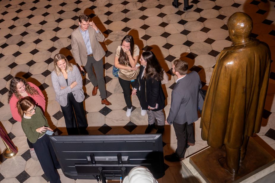 Congressional staffers watch the final minutes of the 14th vote Friday night.