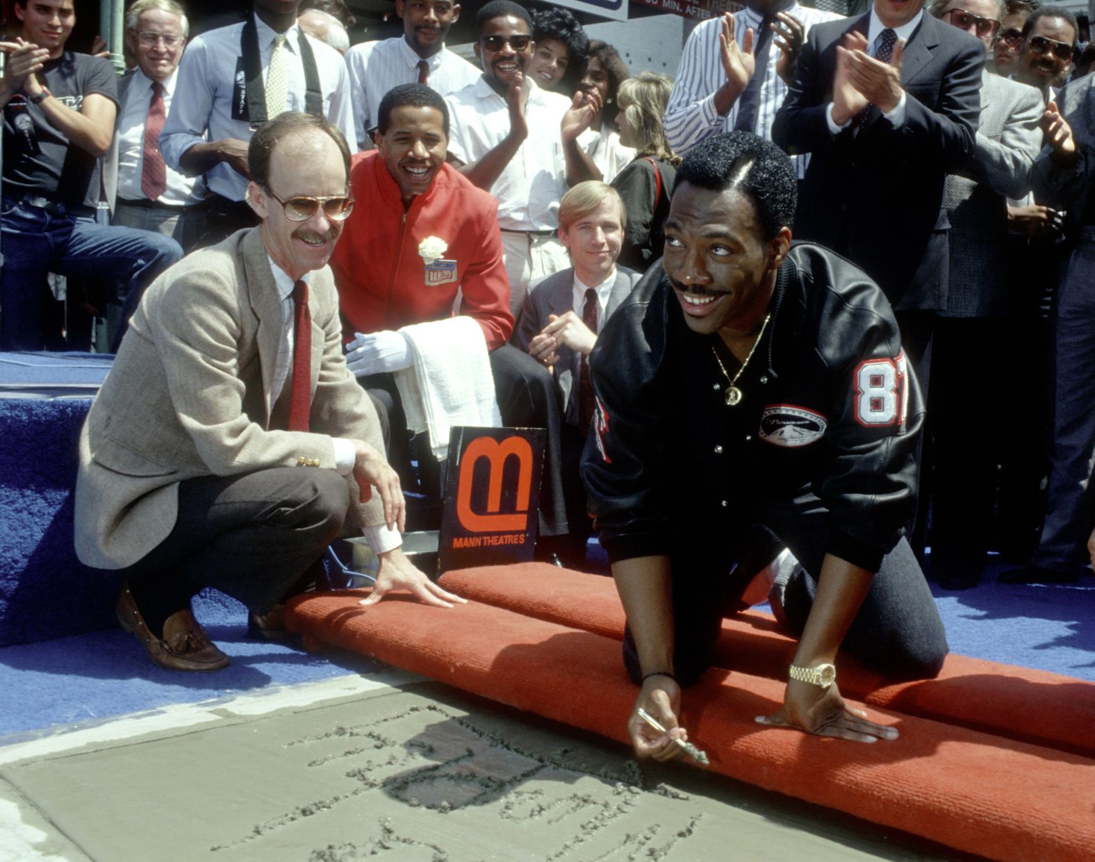 Murphy signs his name in concrete outside Grauman's Chinese Theatre in Hollywood in 1987.