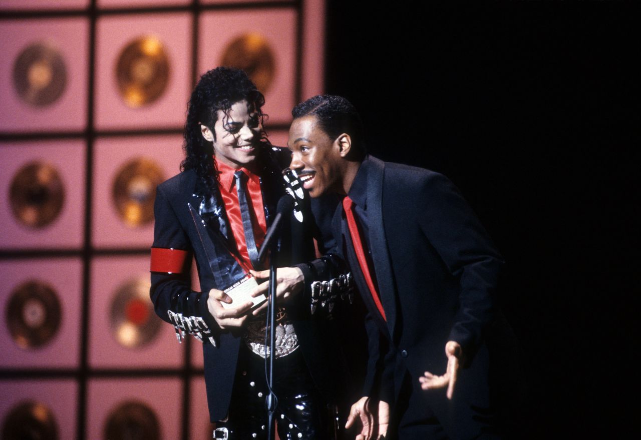 Murphy presents Michael Jackson with a Special Achievement Award at the 1989 American Music Awards. The pair later recorded the duet "Whatzupwitu" in 1993.