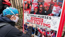 FILE - Zach Clapp, a nurse in the Pediatric Cardiac ICU at Mount Sinai Hospital signs a board demanding safe staffing during a rally by NYSNA nurses from NY Presbyterian and Mount Sinai, Tuesday, March 16, 2021, in New York. Negotiations to keep 10,000 New York City nurses from walking off the job headed Friday, Jna. 6, 2023, into a final weekend as some major hospitals braced for a potential strike by sending ambulances elsewhere and transferring such patients as vulnerable newborns.  (AP Photo/Mary Altaffer, File)