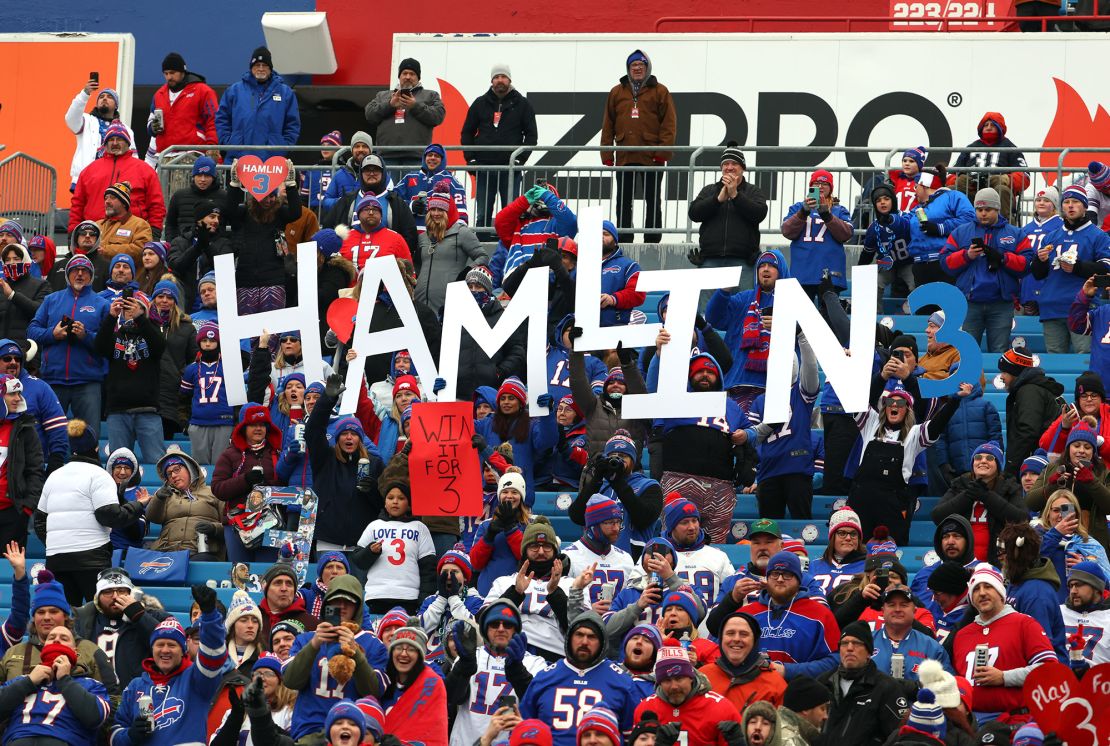 Buffalo Bills fans hold signs in support of Damar Hamlin prior to Sunday's game.