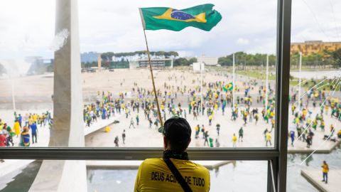 A man waves Brazil's flag as supporters of former President Jair Bolsonaro demonstrate outside the National Congress in Brasília, Brazil, on Dec. 8, 2023.