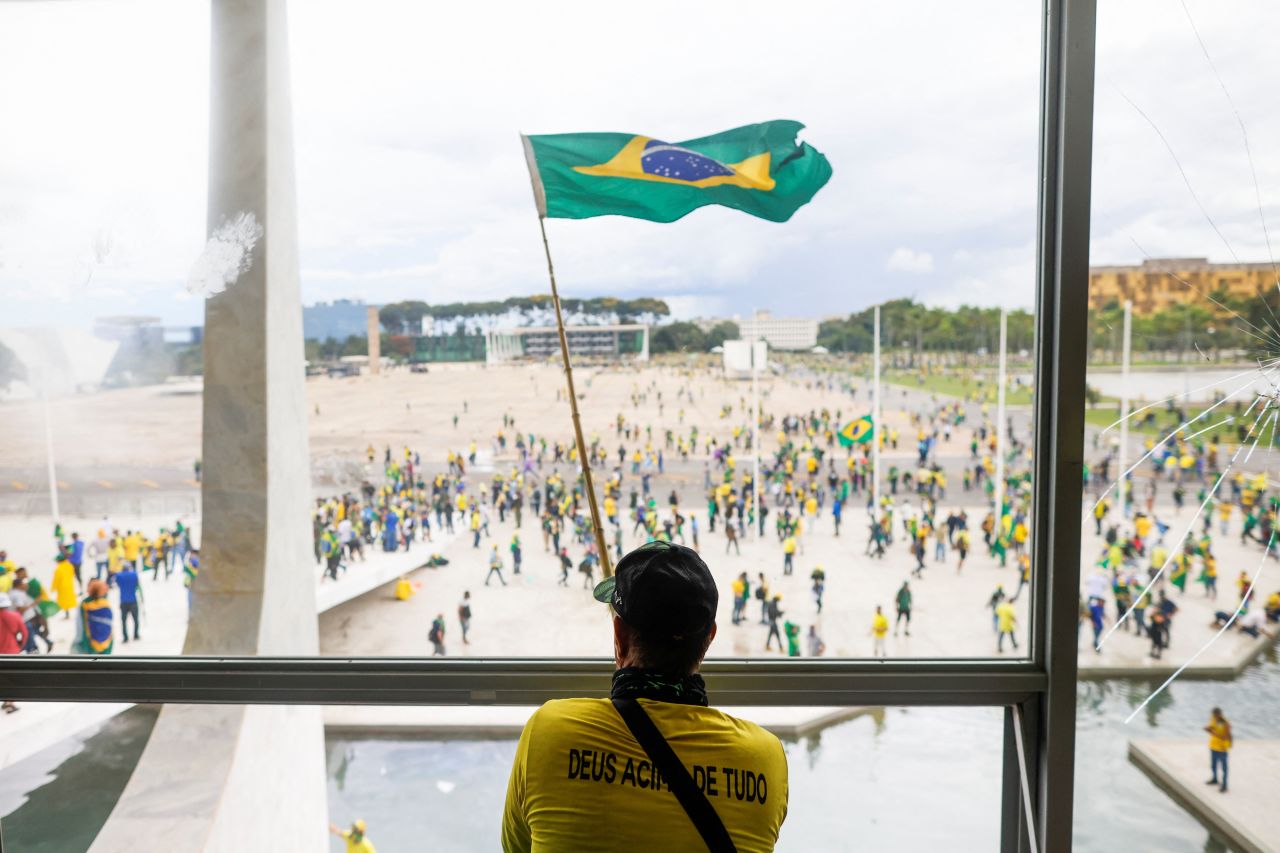 A man waves Brazil's flag from the window of the National Congress in Brasilia.