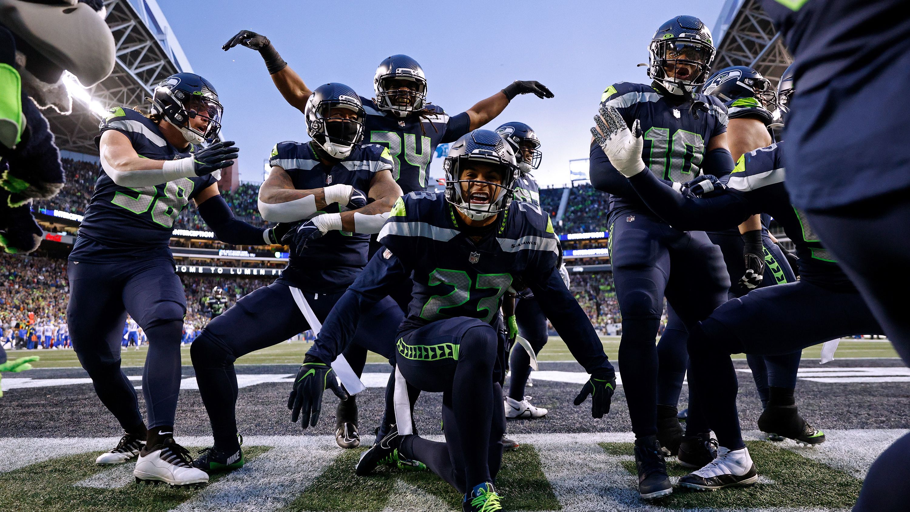 The Seattle Seahawks celebrate an interception by Quandre Diggs against the Los Angeles Rams in overtime at Lumen Field. Thanks to their 19-16 win and the Green Bay Packers' defeat later in the day, the Seahawks claimed a wildcard spot in the NFC playoffs. 