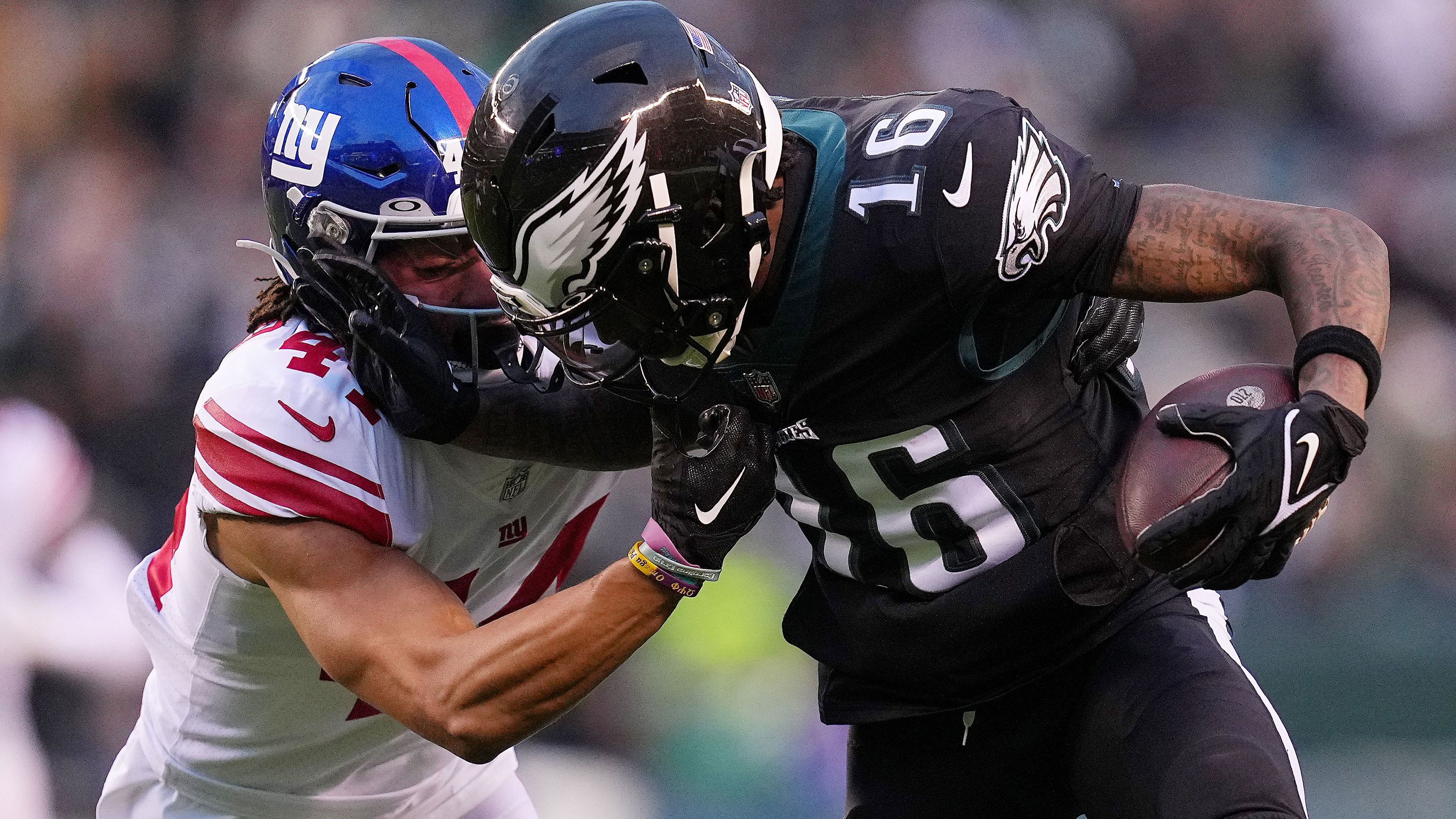 Quez Watkins of the Philadelphia Eagles stiff-arms the New York Giants' Nick McCloud during the first quarter at Lincoln Financial Field. Eagles star quarterback Jalen Hurts returned to the line-up on Sunday and helped the team to a 22-16 win over the Giants, clinching the No. 1 seed in the NFC playoffs. 