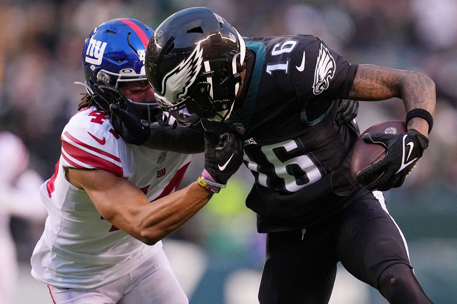 Quez Watkins of the Philadelphia Eagles stiff-arms the New York Giants' Nick McCloud during the first quarter at Lincoln Financial Field. Eagles star quarterback Jalen Hurts returned to the line-up on Sunday and helped the team to a 22-16 win over the Giants, clinching the No. 1 seed in the NFC playoffs. 