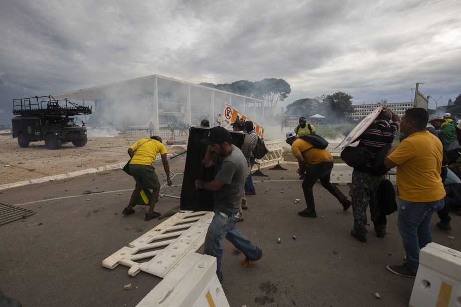 Supporters of former President Jair Bolsonaro clash with security forces as they break into Planalto Palace and raid the Supreme Court in Brasilia.