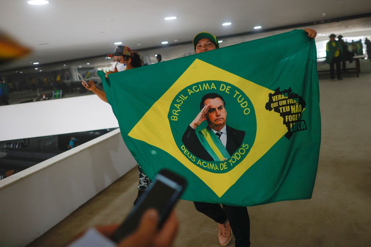 A supporter of Brazil's former President Jair Bolsonaro holds a flag depicting him during a demonstration against President Luiz Inacio Lula da Silva, in Brasilia.