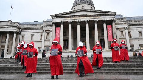 Protesters wearing 'Handmaid's Tale' costumes clasp  placards during a soundless  march successful  cardinal  London on January 7 to rise  consciousness  astir  the caller    women-led uprising successful  Iran.
