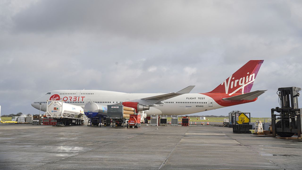 Virgin Orbit's Cosmic Girl 747, which is designed to carry the company's LauncherOne rocket beneath its wing, sits on the apron runway surrounded by technical service equipment at Cornwall Airport on January 8 in Newquay, England.
