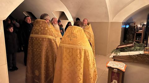 A local priest celebrates Orthodox Christmas in the church crypt under the 'Church of All Saints' in Bakhmut.
