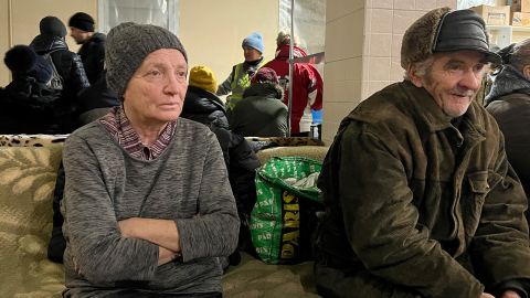 An elderly person sits at one of the shelters in Bakhmut city to receive warmth and a hot drink.