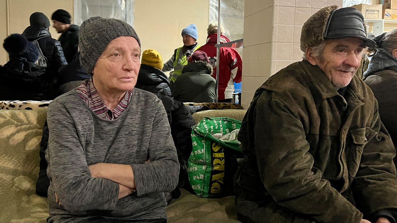 A senior citizen sitting at one of Bakhmut city shelters to receive warmth and hot drinks.