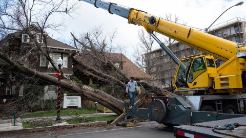 Crane operator Ricky Kapuschinsky prepares to remove fallen trees on Sunday in Sacramento, California.