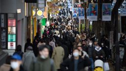 People walk along a street in the Omotesando area in Tokyo, Japan, on Friday, Dec. 9, 2022. 