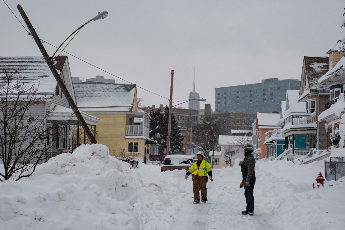 National Grid workers respond to a downed utility pole in Buffalo, New York, on December 27. The damage from the multi-state blizzard is still being calculated. 