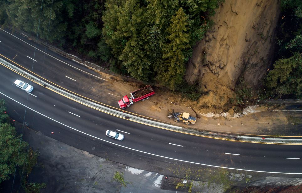 Crews work to clear a mudslide on Highway 17 in Scotts Valley.