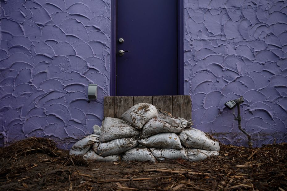 Sandbages are piled in front of a door in Capitola on Friday.