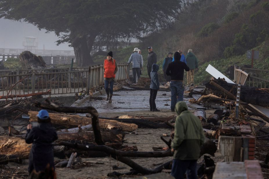 Residents walk in a damaged area of Aptos on January 5.
