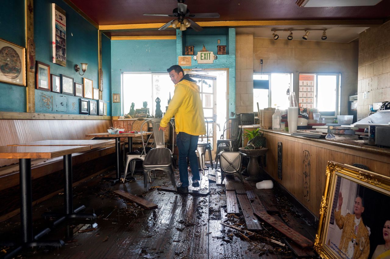 Dominic King, owner of the restaurant My Thai Beach, surveys storm damage at his business in Capitola.