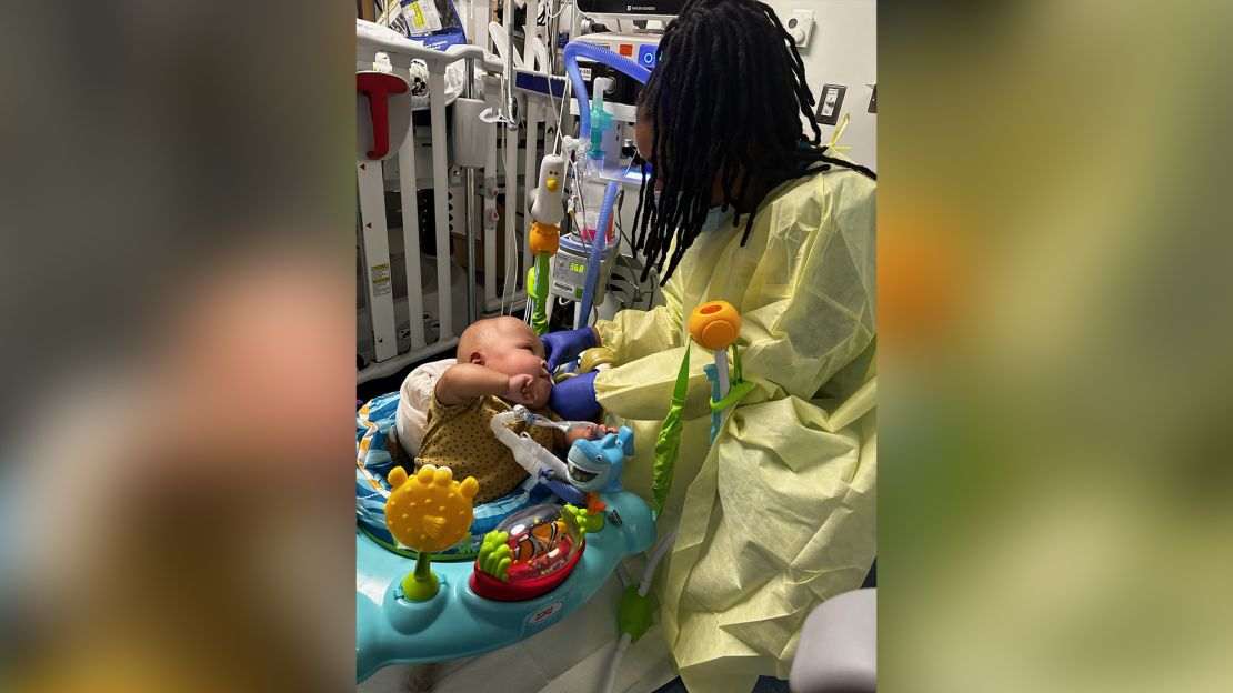 Lora Ribas' son Logan, seen at Mount Sinai with Shernette, a primary care nurse caring for the one-year-old neonatal intensive care unit patient. 