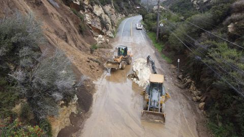 Caltrans workers chip away at a huge boulder that fell on Malibu Canyon Road in Malibu, California, on January 10, 2023.  