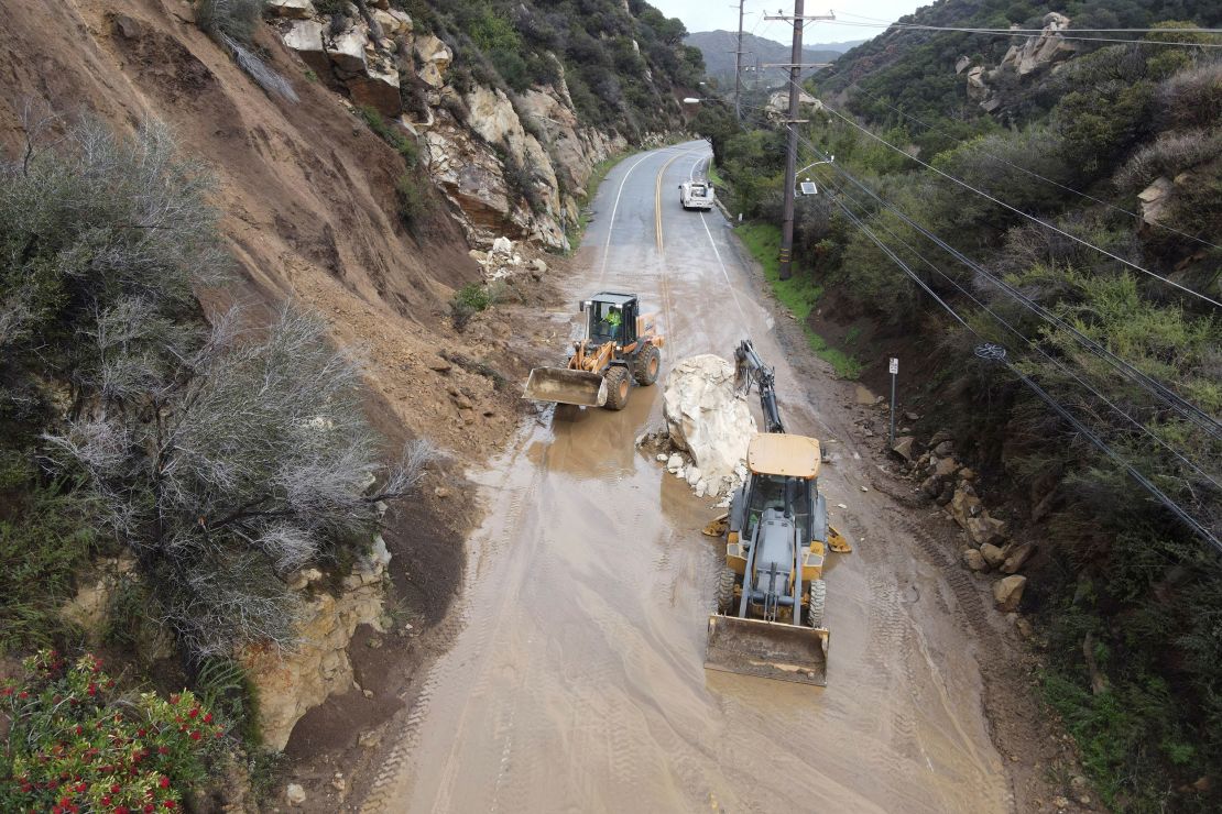 Caltrans workers chip away at a huge boulder that fell on Malibu Canyon Road in Malibu, California, on January 10, 2023.  