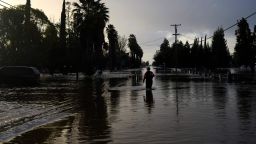 A San Diego firefighter wades through floodwaters to help rescue animals in Merced, California, on January 10, 2023. Relentless storms were ravaging California again Tuesday, the latest bout of extreme weather that has left 14 people dead. Fierce storms caused flash flooding, closed key highways, toppled trees and swept away drivers and passengers -- reportedly including a five-year-old-boy who remains missing in central California. 