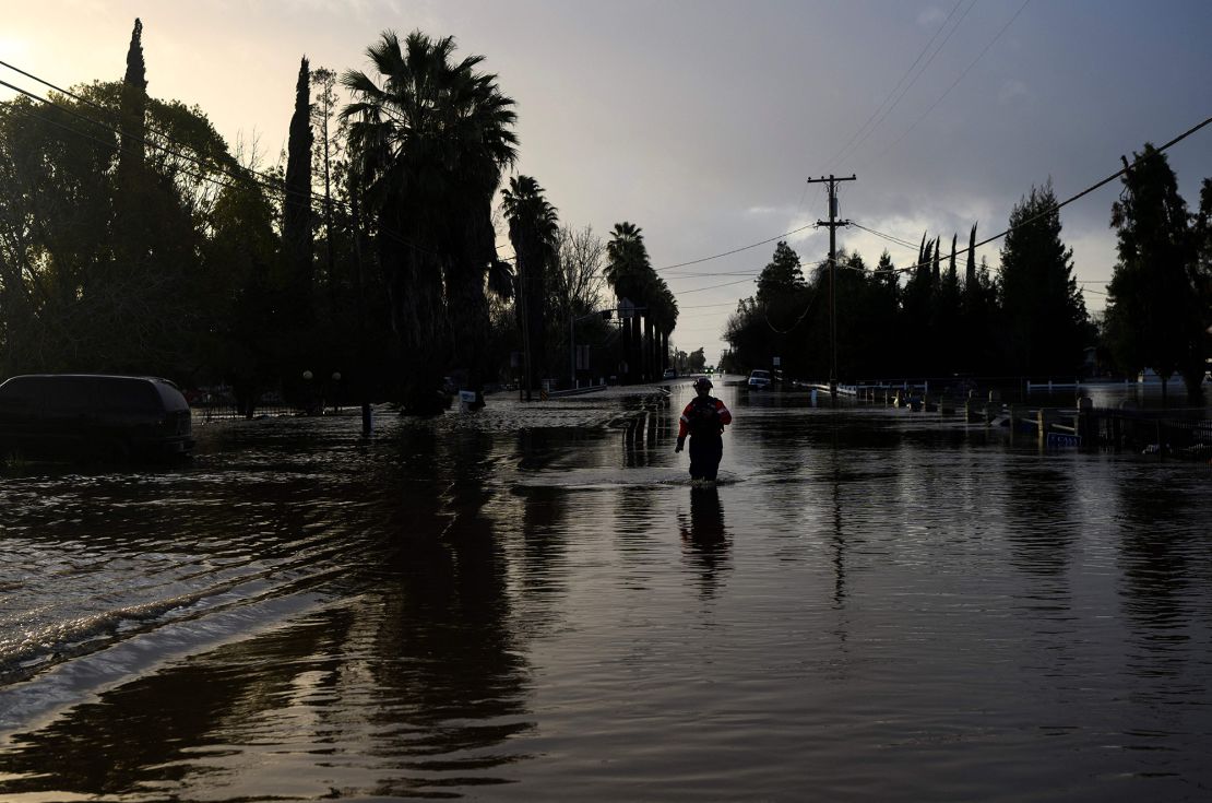 A San Diego firefighter wades through floodwaters in Merced, California, on Jan. 10, 2023. Climate concerns topped long-term risks in a survey of global experts by the World Economic Forum.