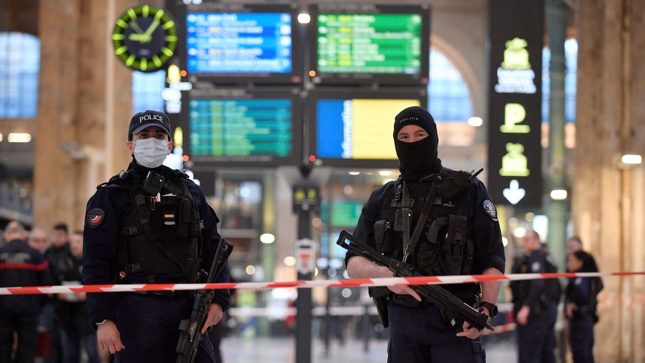 French police stand guard in a cordonned off area at Gare du Nord station, where an attack cut off access to major train services.