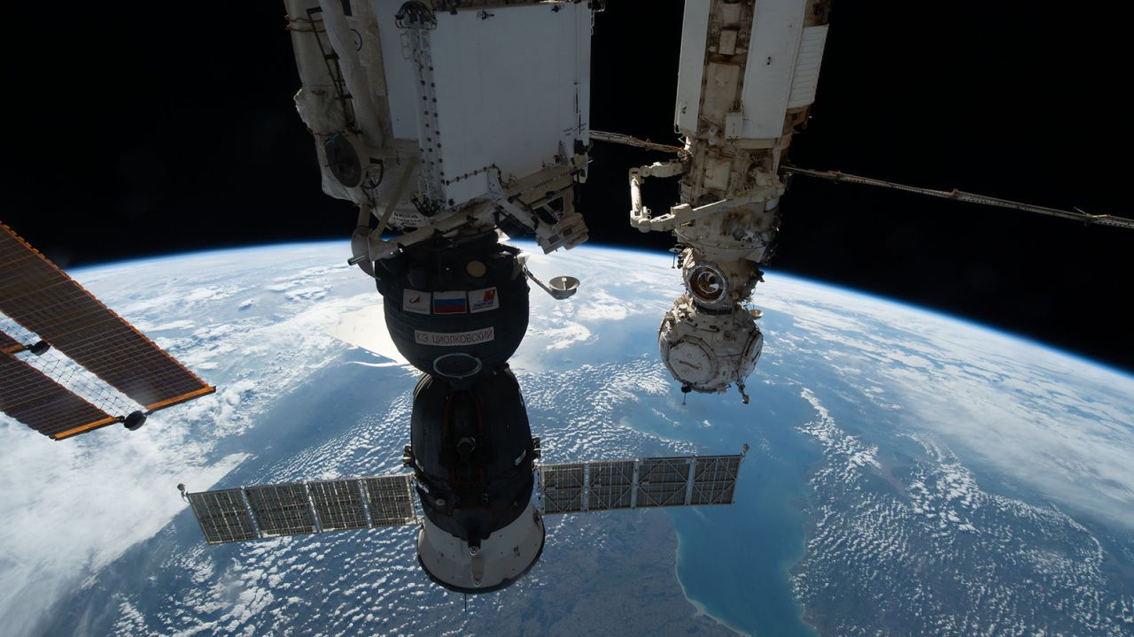 The Soyuz MS-22 crew ship (foreground) is shown on October 8, 2022, docked to the International Space Station. The capsule sprang a leak in December; now its replacement capsule's launch is delayed.