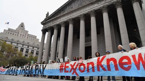 Climate activists on the first day of  ExxonMobil's trial outside the New York State Supreme Court building in October 2019. Exxon won the case, which alleged the company had misled over climate change.