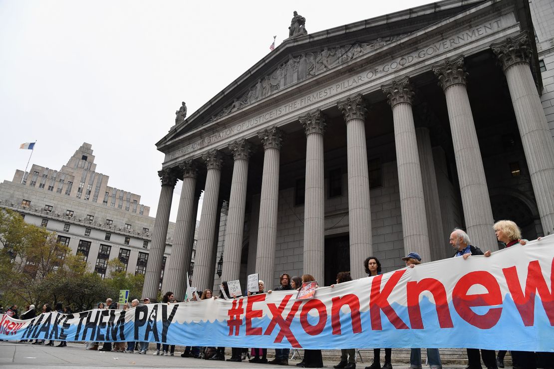 Climate activists on the first day of  ExxonMobil's trial outside the New York State Supreme Court building in October 2019. Exxon won the case, which alleged the company had misled over climate change.