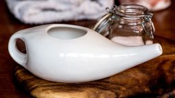 neti pot, ayurvedic tools for cleaning nose with water and salt,  on a wooden table