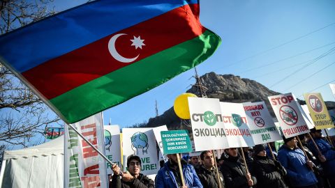 An Azerbaijani protester waves a national flag during a protest on the Armenian-majority breakaway Nagorno-Karabakh region's only land link with Armenia, on December 27, 2022. 