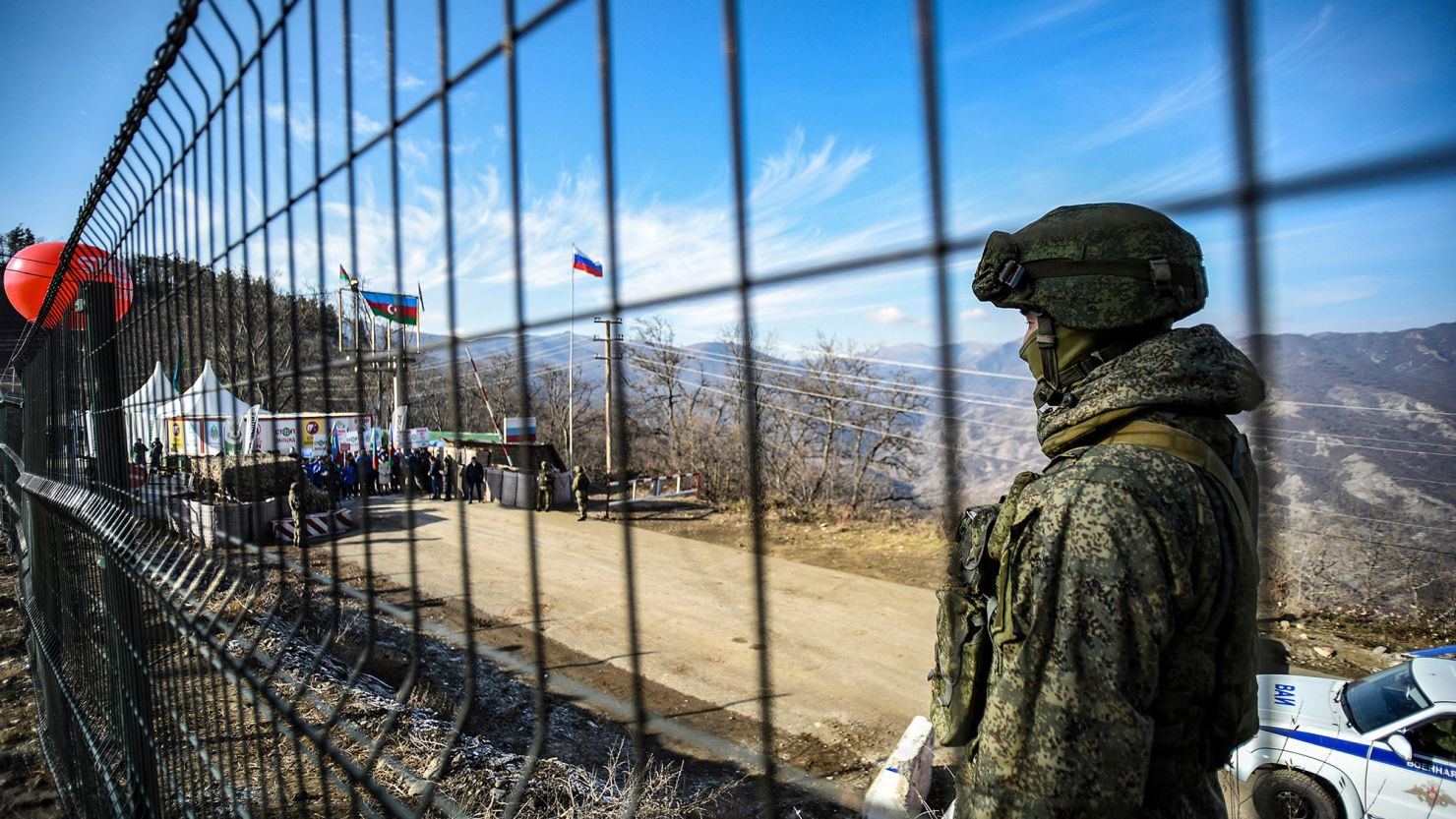 A Russian peacekeeper guards the Lachin corridor, the Armenian-majority breakaway Nagorno-Karabakh region's only land link with Armenia, on December 27, 2022, as demonstrators stage a protest. 