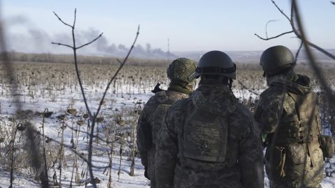 Ukrainian soldiers watch as smoke billows during fighting in Soledar on Wednesday.