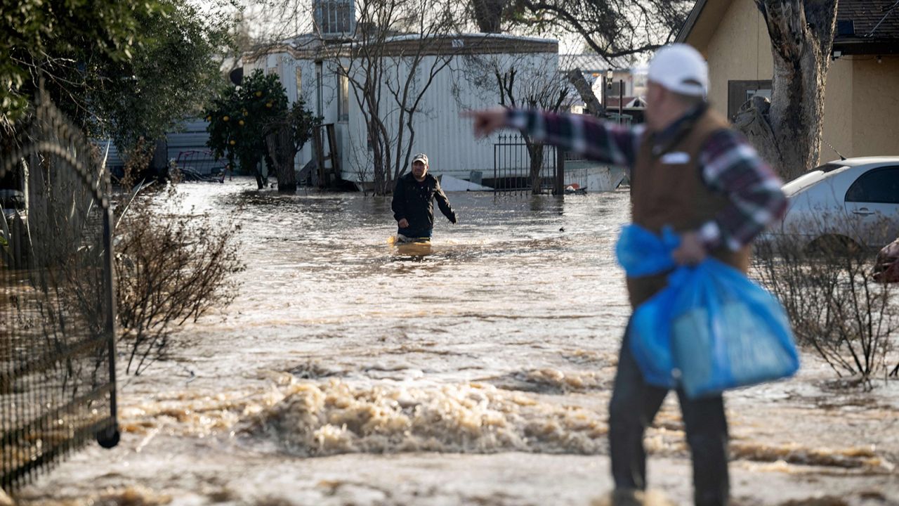 Residents scramble to retrieve belongings before flood waters rise too high Merced, California, on January 10, 2023. 
