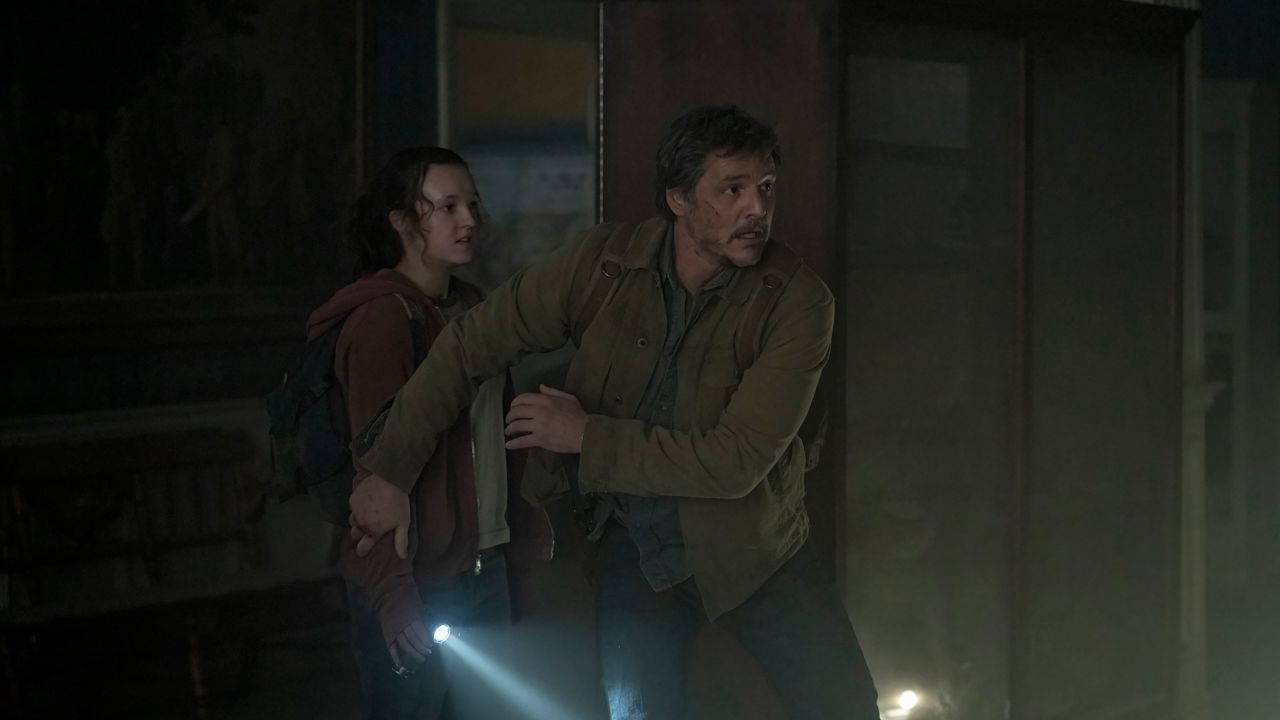 Bella Ramsey's Ellie is shielded by Pedro Pascal's Joel in "The Last of Us." 
