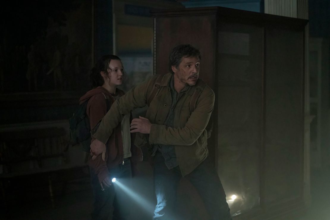 Bella Ramsey's Ellie is shielded by Pedro Pascal's Joel in "The Last of Us." 