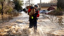 San Diego firefighter Brian Sanford rescues a dog from a flooded home in Merced, California, on January 10, 2023.