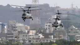 In this Aug. 16, 2012 photo, CH-46 helicopters take off from the U.S. Marine Corps base in Futenma , in Okinawa, Japan. Okinawa Gov. Hirokazu Nakaima signed off Friday, Dec. 27, 2013, on the long-awaited relocation of the U.S. military base, a major step toward allowing the U.S. to move forward with plans to consolidate its troops in Okinawa and move some to Guam. Nakaima approved the Japanese Defense Ministry's application to reclaim land for a new military base on Okinawa's coast. It would replace the U.S. Marine Corps base in Futenma, a more congested part of Okinawa's main island. (AP Photo/Greg Baker)