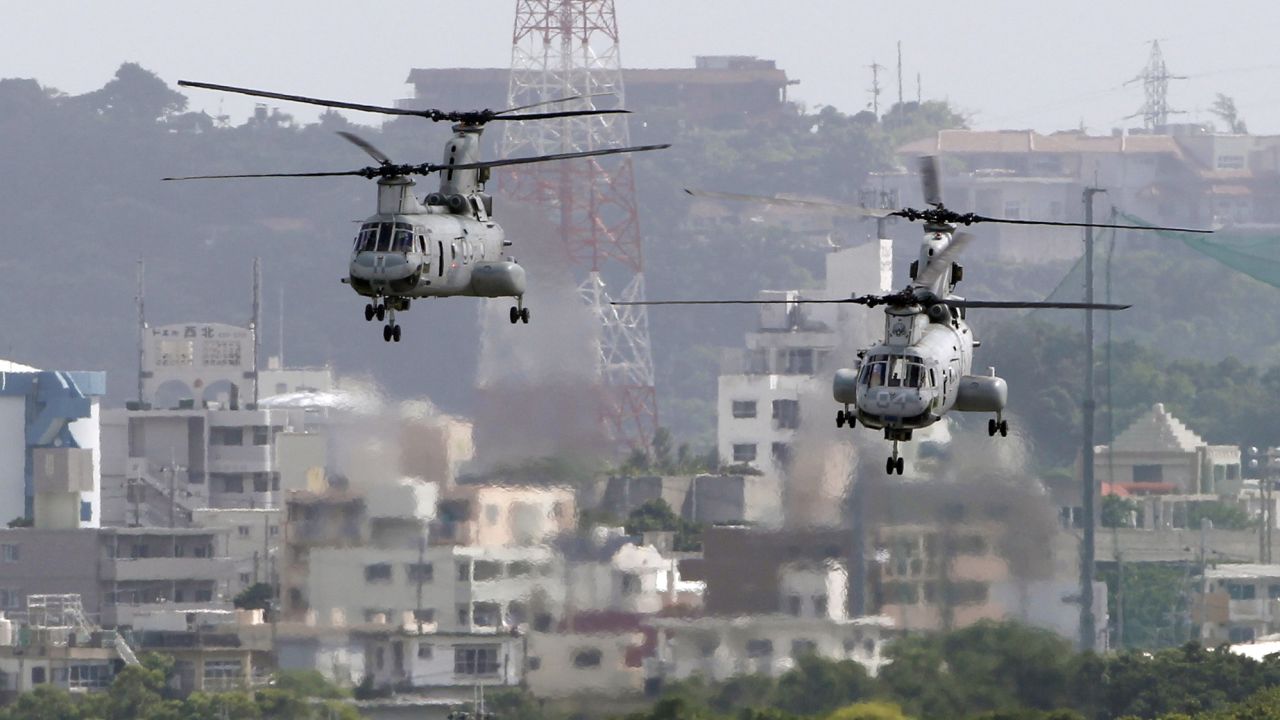 In this Aug. 16, 2012 photo, CH-46 helicopters take off from the US Marine Corps base in Futenma , in Okinawa, Japan. 