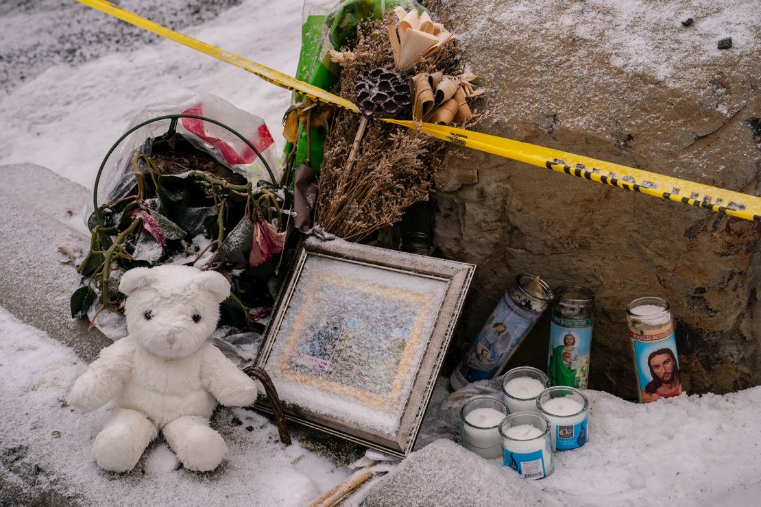 Mourners leave a makeshift memorial outside the scene of the killings. 