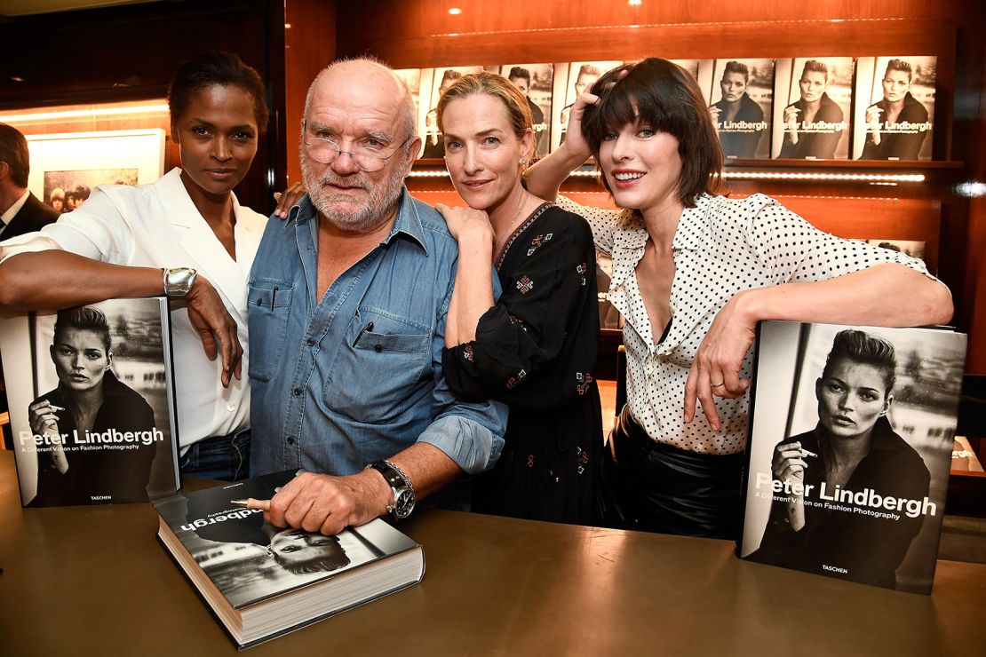 Patitz (second from right) hangs on the shoulder of longtime collaborator Peter Lindbergh, flanked by models Karena Alexander (left) and Milla Jovovich, in 2016. 