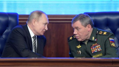 Russian President Vladimir Putin listens to Valery Gerasimov during the annual meeting of the Defense Ministry's council in Moscow on December 21, 2021.