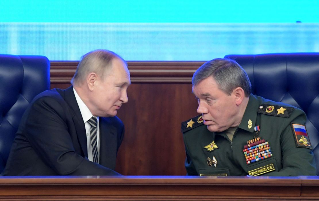 Russian President Vladimir Putin listens to Valery Gerasimov during the annual meeting of the Defence Ministry board in Moscow on December 21, 2021.
