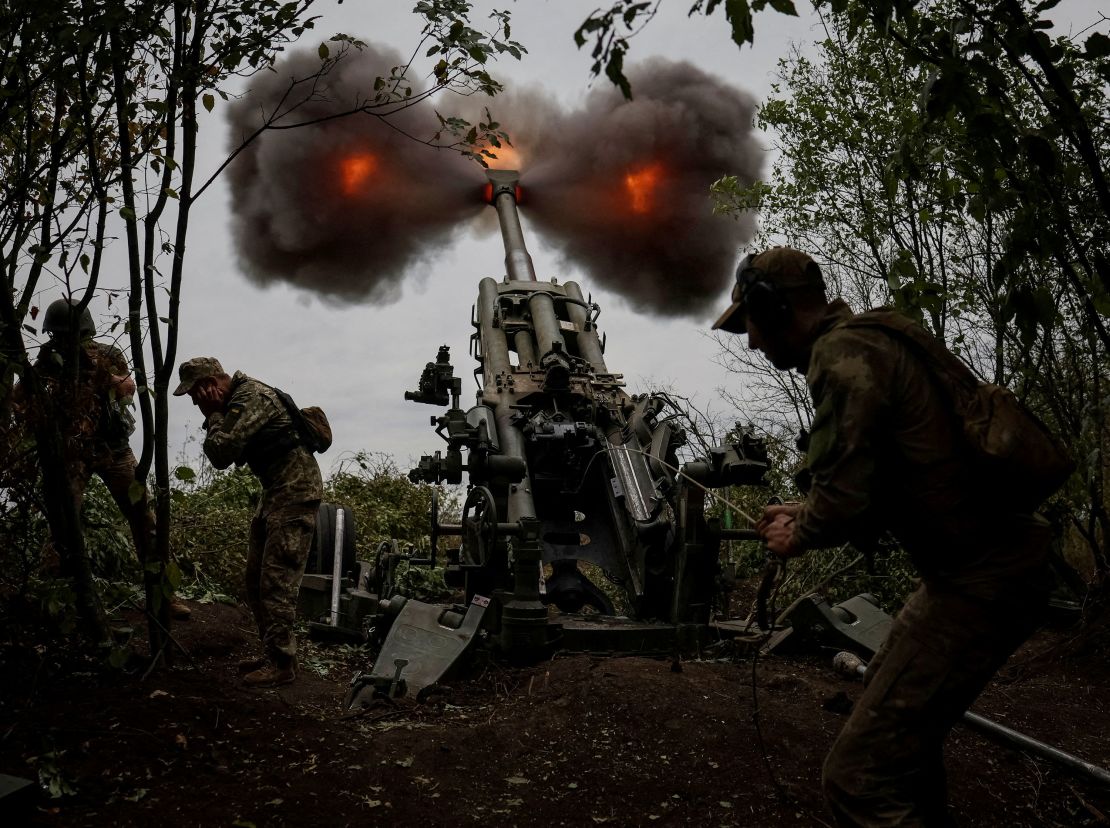 Ukrainian service members fire a shell from an M777 Howitzer at a front line, as Russia's attack on Ukraine continues.