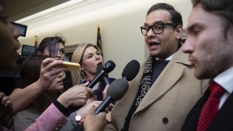 Rep. George Santos speaks with reporters Wednesday as he leaves his office on Capitol Hill.