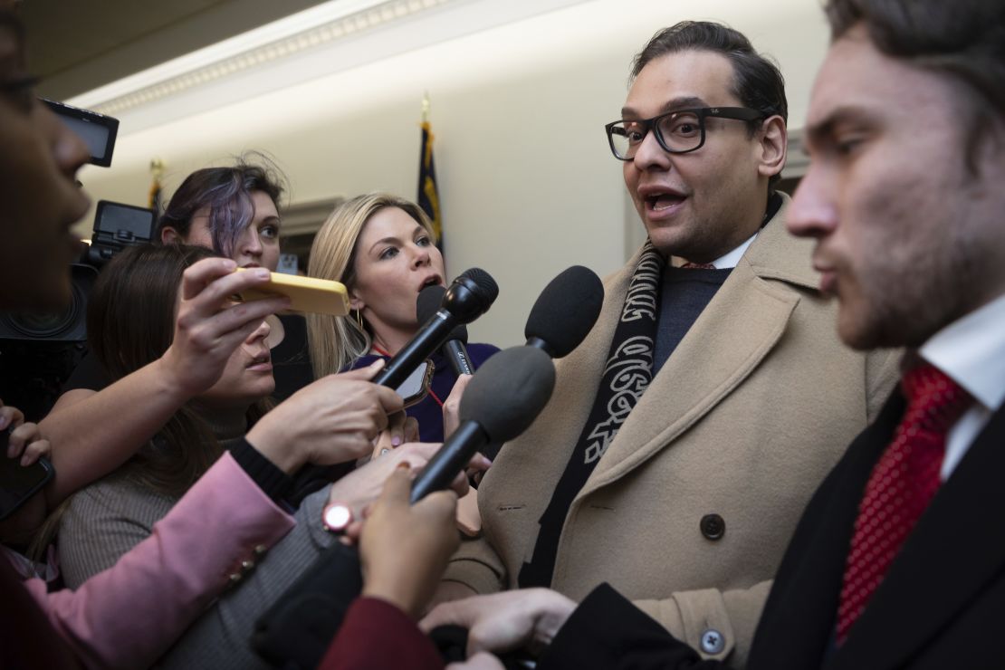 Rep. George Santos speaks with reporters Wednesday as he leaves his office on Capitol Hill.